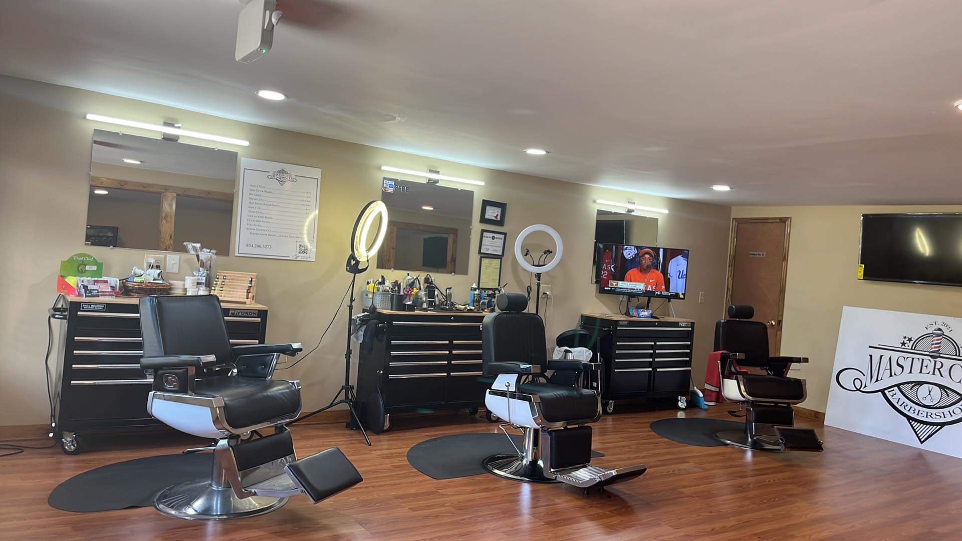 Three barber chairs and mirrors inside Master Cuts