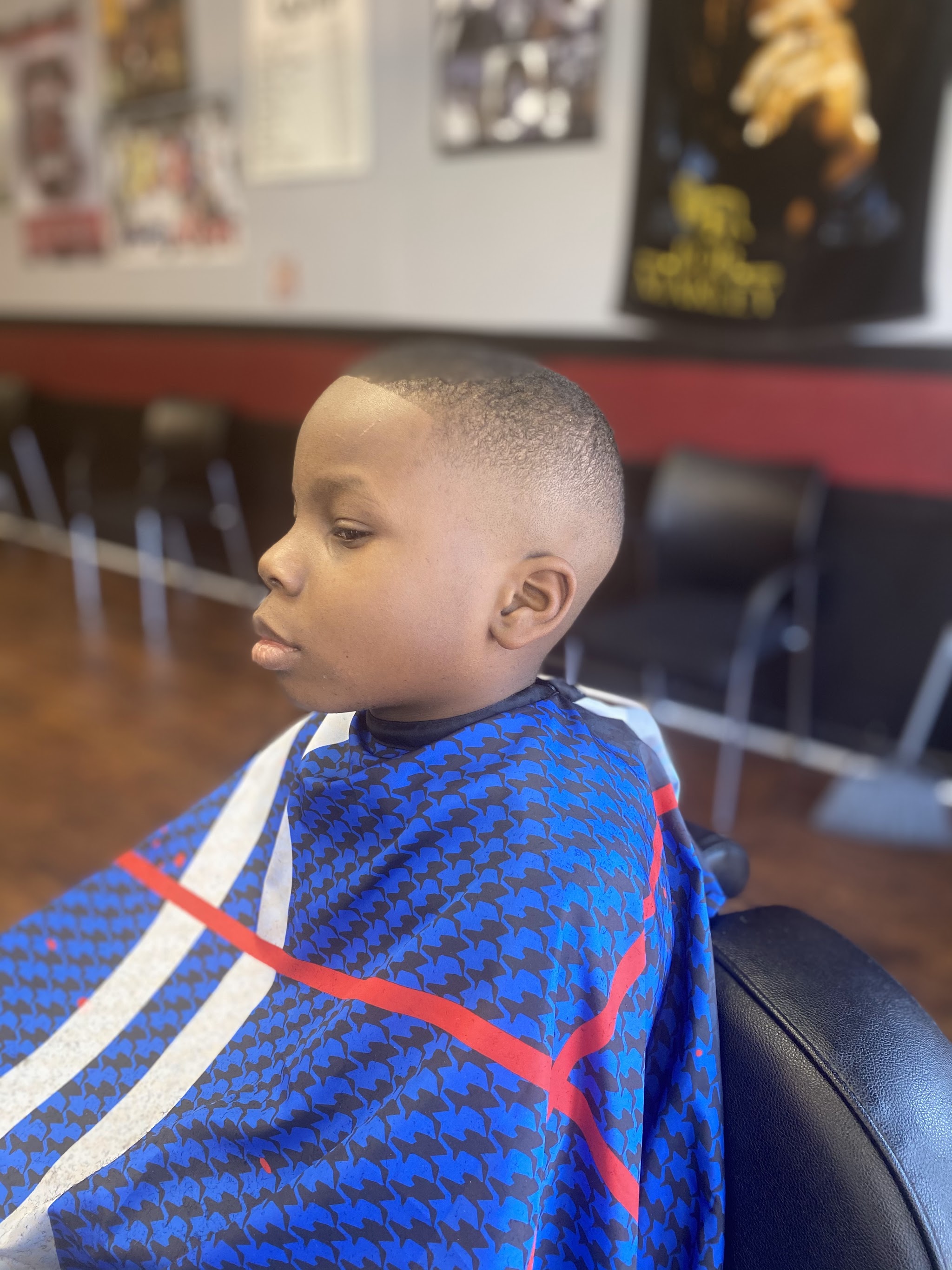 A kid in the chair with a fresh fade